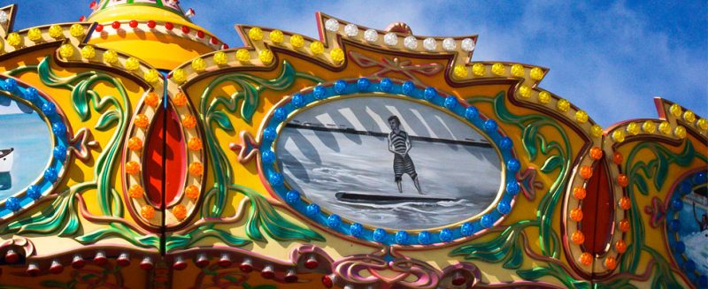 Surfer Art On Top Of The Sea Swings Ride