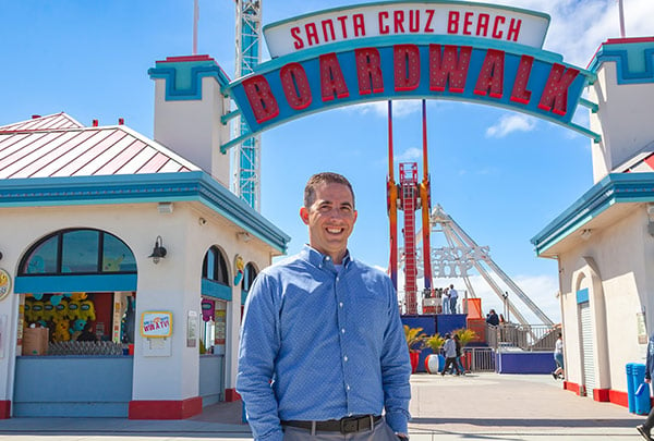 Eric Summers in front of Boardwalk sign